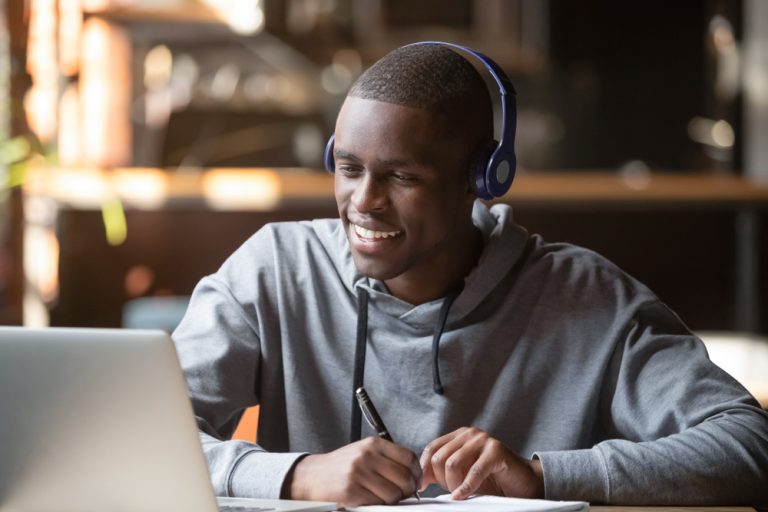 Smiling,African,Young,Man,Student,Wear,Headphones,Looking,At,Laptop